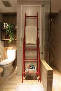 a red bunk bed in a bathroom with a toilet at Panoramic View Grand Kamala Lagoon in Bekasi