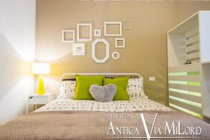 A bed or beds in a room at Dimora Antica Via MiLord