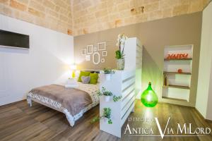 A bed or beds in a room at Dimora Antica Via MiLord