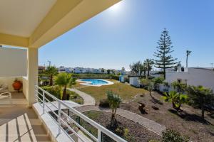 a balcony of a house with a swimming pool at Villas Sol e Poesia in Albufeira