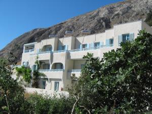 a building on the side of a mountain at Villa Anneta in Kamari +27 photos