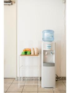 a small white refrigerator next to a small table at Fujieda Ogawa Hotel フジエダオガワホテル in Fujieda