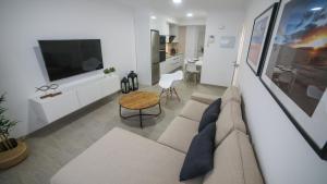 a living room with a couch and a table at Brazan Holidays in Corralejo