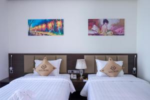 Postel nebo postele na pokoji v ubytování Sata Hotel