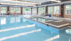 a large swimming pool with blue water in a building at Park Place Hotel & Conference Center in Traverse City