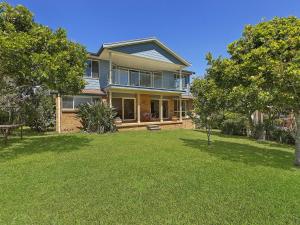 a large house with a lawn in front of it at Stunning Ocean Views in Norah Head
