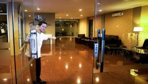 a man is standing in a lobby at Raden Wijaya Hotel & Convention in Mojokerto