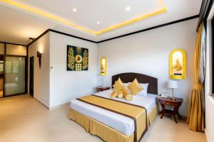 a hotel room with a bed and a table at Poseidon Boutique Hotel in Pattaya South