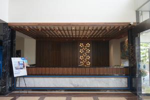 a lobby of a building with a wall with writing on it at Hotel Brothers Biru Solo Baru in Solo