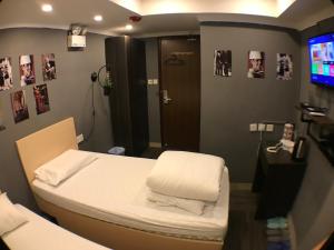 a hospital room with a bed and a tv at Soso Hostel in Hong Kong