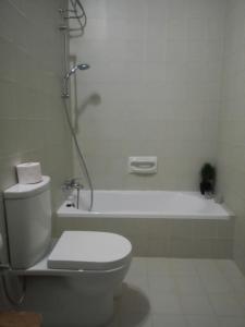 a bathroom with a toilet and a bath tub at Squadron Base in Luqa