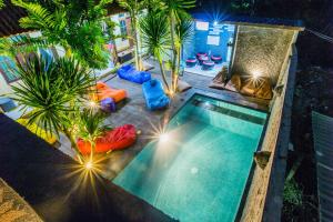 an overhead view of a swimming pool at night at Suba Homestay in Nusa Lembongan