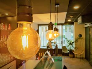 a large light bulb hanging over a counter in a store at Hôtel Boutique Richelieu, Lyon Gare Part-Dieu in Lyon