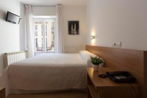 Postel nebo postele na pokoji v ubytování Hostal La Numantina