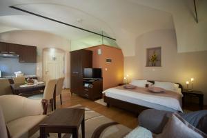a bedroom with a bed and a living room at Sobe Bernarda in Varaždinske Toplice