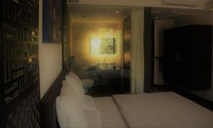 a bedroom with a bed and a view of a bathroom at Lotus Sutra in Arambol