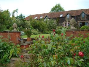 a garden with flowers and a house in the background at Cutty Sark Cottage in Kirkton of Largo +8 photos
