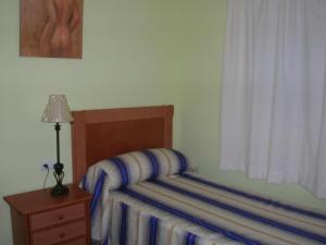 Posteľ alebo postele v izbe v ubytovaní VTV Amores Residencial2000