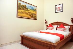 מיטה או מיטות בחדר ב-OYO 465 Alam Citra Bed & Breakfast