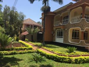 a house with a garden in front of it at Mama Thea homes in Moshi