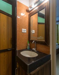 a bathroom with a sink and a mirror at Moustache Goa Cowork Hostel in Mandrem +17 photos
