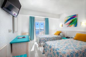 Postel nebo postele na pokoji v ubytování Hotel Servigroup Torre Dorada
