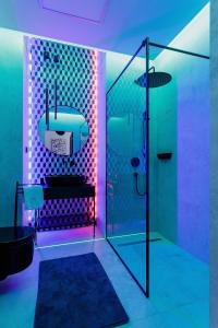 a bathroom with a shower with purple lights at Apartments Kraków Masarska Free Parking by Renters in Krakow