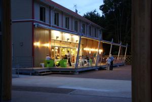 een winkel met mensen in stoelen voor een gebouw bij Le Port de Decize in Decize