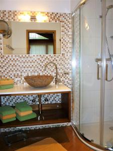 a bathroom with a sink and a glass shower at Ferienhaus Ambiente in Ofterschwang