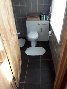 a bathroom with a toilet and a tiled floor at 24 Fairfield Road in Uttoxeter