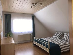 a small bedroom with a bed and a window at Ferienwohnung Jutta u. Andreas Arenz in Minderlittgen