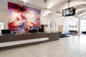 a lobby with a large painting on the wall at Comwell Kolding in Kolding