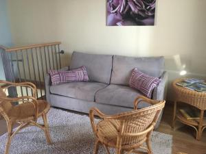 a living room with a couch and two chairs at Casetta dei Lupi in Miazzina +5 photos