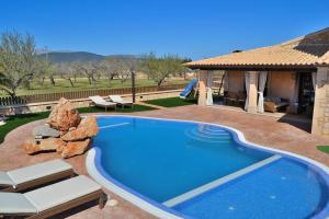 a swimming pool in a yard next to a house at 065 Finca Son Costa ETV4943 by Mallorca Charme in Búger
