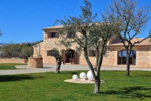 a house with a tree and two white eggs in the grass at 065 Finca Son Costa ETV4943 by Mallorca Charme in Búger