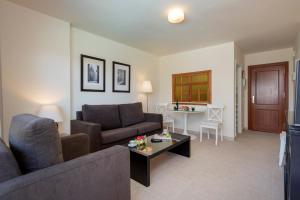 a living room with a couch and a table at Apartamentos Nucleo Cristal in Torremolinos