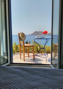 a room with a window looking out at the ocean at Enalion House in Agios Ioannis Kaspaka