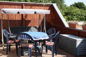 a table and chairs with a canopy on a patio at Ferienwohnung 2 in Dargen
