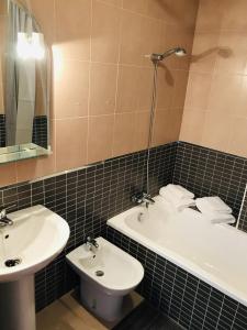 a bathroom with a sink and a tub and a toilet at El Toyo - Cabo de Gata in Almería
