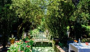 a white bench sitting in a garden with flowers at Villa Beukenhof in Oegstgeest