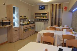 a restaurant with two tables and a kitchen with a counter at Casa Citella in Bussolengo