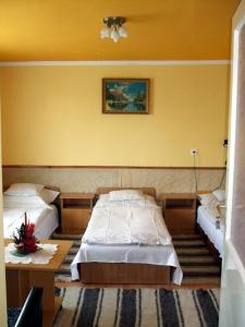 A bed or beds in a room at Lugas Szallas