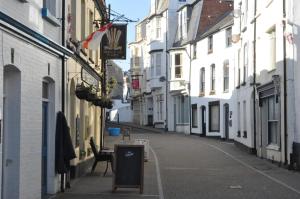 an empty street with a chair in an alley at The Salt House, Fore Street in Ilfracombe