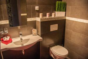 a bathroom with a sink and a toilet at M0 Caffe & Motel in Nagytarcsa