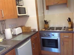 
A kitchen or kitchenette at Stable Cottages
