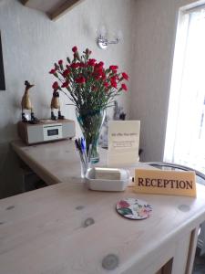 a table with a vase of flowers on a counter at Stoneleigh Hotel in Skegness