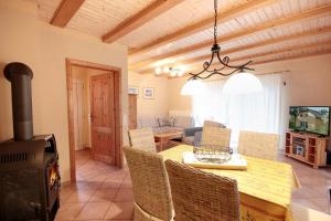 a kitchen and dining room with a table and a stove at Haus Baabe by Rujana in Baabe