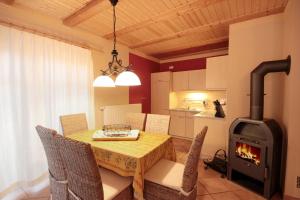 a dining room with a table and a wood stove at Haus Baabe by Rujana in Baabe