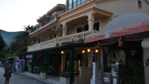 a building with people walking in front of it at Apartments Adriatico in Herceg-Novi