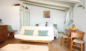 a bedroom with a bed and a chair and a table at Monte das Cortelhas in Guia +50 photos